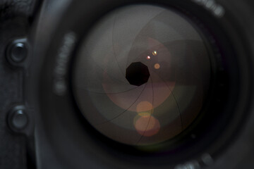 Camera lens in detail, open aperture with reflections
