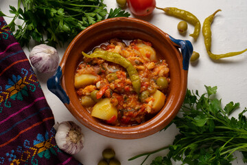 Mexican style cod called a la vizcaina on white background