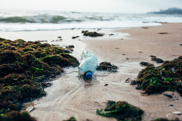 Garbage and water bottle on beach