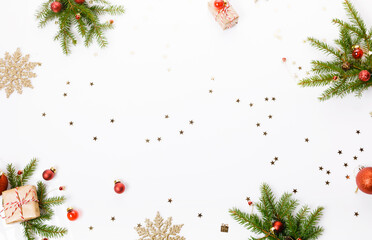 Fototapeta na wymiar Christmas or New Year background, composition made of red Xmas decorations, gifts and fir branches on white background, flat lay