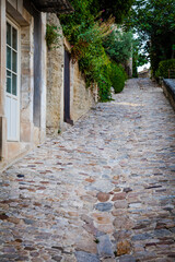 Old houses in the streets of the ancient village Lacoste in Provence, France