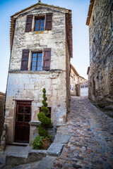 Old houses in the streets of the ancient village Lacoste in Provence, France