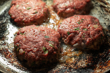 Burger patties at the cooking plate
