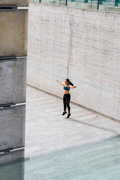 Young woman during workout on square