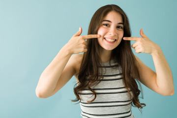 Fototapeta premium Attractive young woman showing her beaming smile