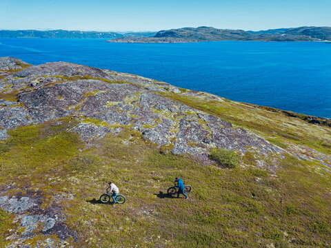 Russia, Murmansk region,&not;&dagger;Kolsky&not;&dagger;District, Teriberka, Two men with bicycles on coastline, aerial view