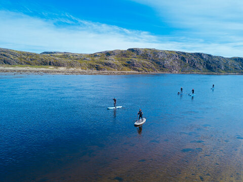 Russia, Murmansk Oblast,&not;&dagger;Kolsky&not;&dagger;District, Teriberka, Sup surfers on&not;&dagger;Teriberka&not;&dagger;river, aerial view