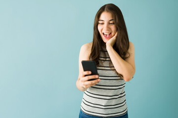 Young woman just received very good news on her cellphone