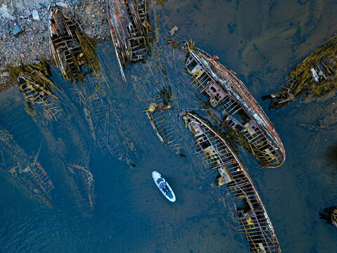 Russia, Murmansk region,&not;&dagger;Kolsky&not;&dagger;District, Teriberka, Sup surfer near shipwrecks on Barents Sea coast, aerial view