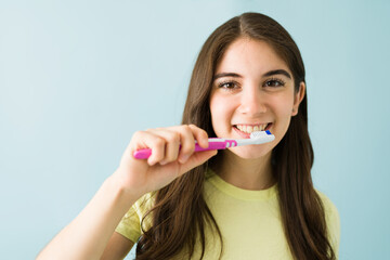 Beautiful woman with a big smile about to brush her teeth