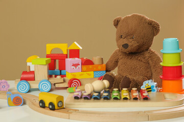 Colorful cildren's toys on table, wooden, plastic and plush toys