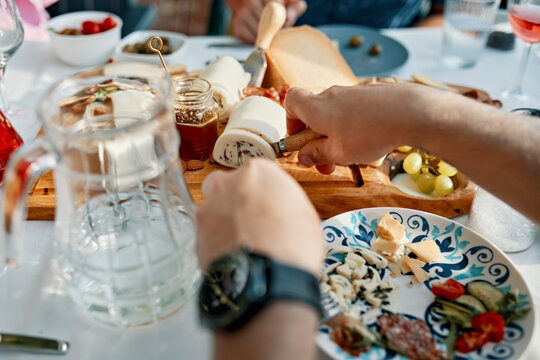 Friends having dinner with a cheese platter