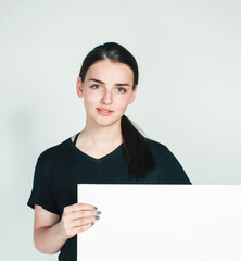 young pretty brunette girl with placard shit copyspace on white background wearing business costume student