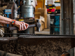 Close up of hand of female blacksmith at work