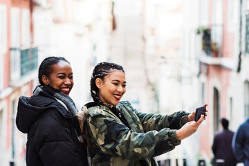 Two young women taking selfie outdoors