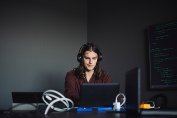 Contemplating IT professional working in creative office