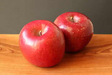 Fuji apples on a wooden plate, isolated