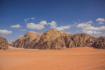 Fototapeta na wymiar picturesque beautiful desert landscape panoramic scenic view nature photography in Wadi Rum famous touristic site of Jordan Middle East country region rocky mountains background