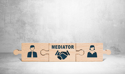 Wooden puzzle with icons of a man, mediator and woman. The concept of the role of a mediator in...