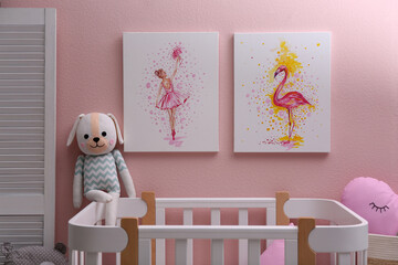 Beautiful pictures of flamingo and ballerina on pink wall in baby room. Interior design