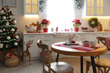 Beautiful kitchen interior with Christmas tree and festive decor