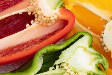 Close-up of colorful chilies cut in half with showing seeds on white background