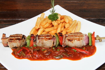 Pork skewer gypsy style served with French fries and sauce