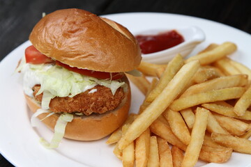Crispy chicken burger served with French fries and ketchup