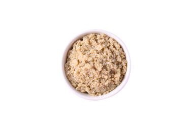 Cooked brown quinoa seeds in a bowl isolated on white background, Top view, Healthy vegan food