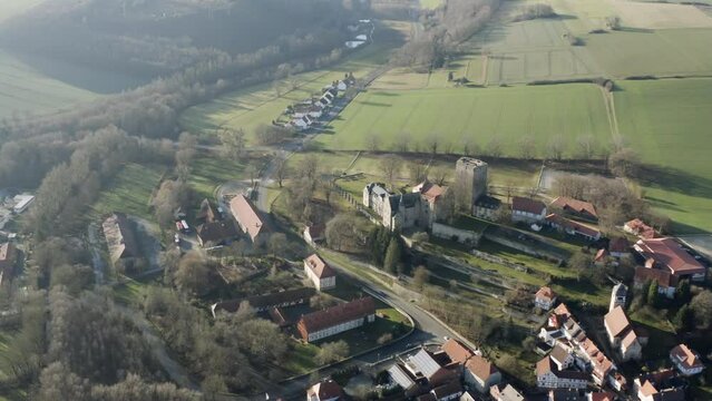 Drone aerial view of the fairytale castle Adelebsen on a beautiful autmn afternoon in golden sunlight. Adelebsen is a historic medieval town Flecken near G&ouml;ttingen in Niedersachsen, Germany.
