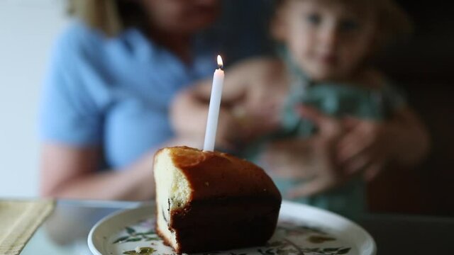 One candle on top of birthday cake, one year old celebration
