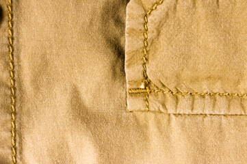clothing items stonewashed cotton fabric texture with seams, clasps, buttons and rivets, macro