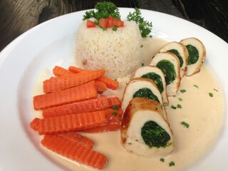 Spinach stuffed chicken breast with cream sauce and steam rice