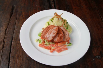 German pork loaf on creamy vegetables with potato mash topped with crispy onions