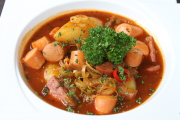 Potato goulash with sausages and bacon