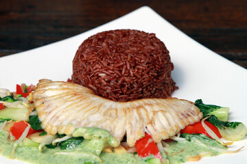 Grilled skate wing on creamy dill vegetables served with red steamed rice