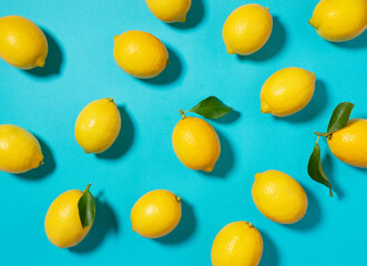 Multiple lemons placed on a blue background
