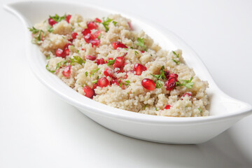 Couscous salad with pomegranate and  chopped parsley leaves