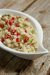Couscous salad with pomegranate and  chopped parsley leaves