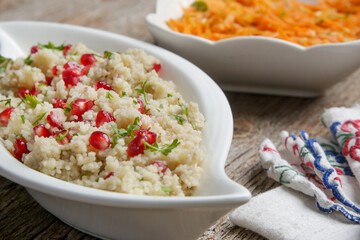 Couscous salad with pomegranate and  chopped parsley leaves