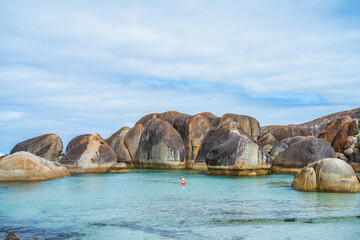 A lone person at Elephant Rocks in Denmark, Australia. 