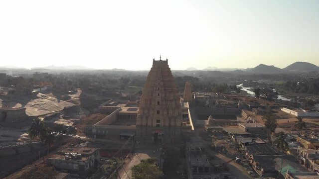 Top view of Virupaksha Temple amidst near the banks of Tungabhadra River in Hampi, India - Aerial Orbit Point of interest shot