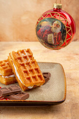 front view yummy waffle cakes with chocolate bars on brown background cookie biscuit cake sweet dessert xmas