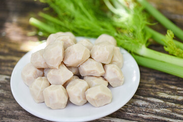 Meat ball on white plate and vegetable on wooden background, meat ball with pork and ingredient for cooked asian thai food.