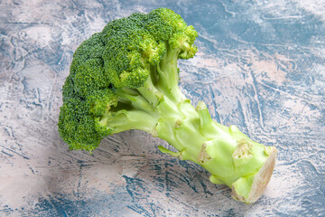 Front close of view of fresh vitamin bom green broccoli on gray background