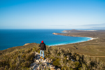 Lone man standing on the top of East Mount Barren as the sun rises behind him. Located in the...