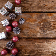 Christmas still life with balls and cones on a wooden background.