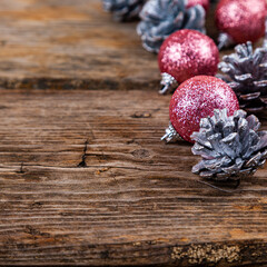 Christmas still life with balls and cones on a wooden background.