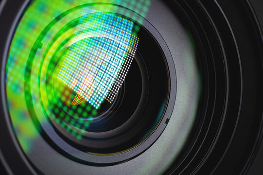 Close-up of a camera mirror lens front lens with aperture and highlights from a light source