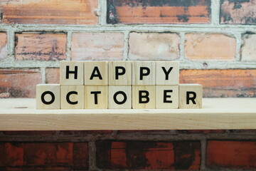 Happy October alphabet letter on shelves wooden background